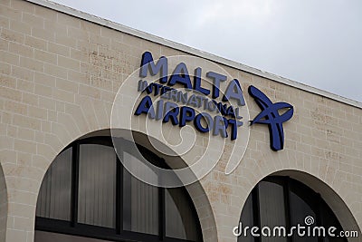 Front view of the sign `Malta International Airport` above the main entrance of the international airport of Malta Editorial Stock Photo