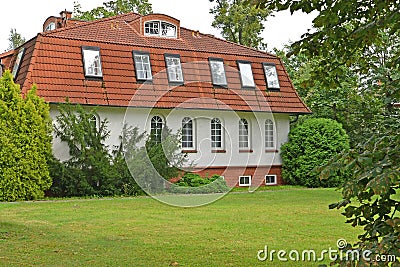 The guest house among coniferous trees. Kaliningrad Stock Photo