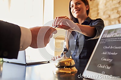 Guest takes room key card at check-in desk of hotel, close up Stock Photo