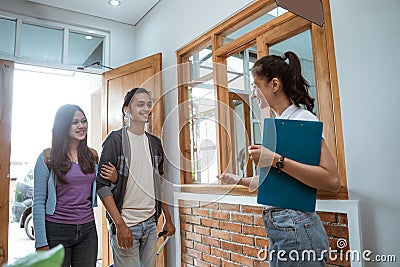 guesthouse staff welcoming couple in boutique hotel Stock Photo