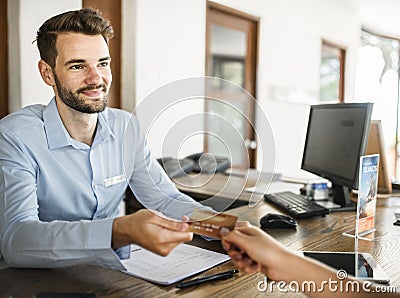 Guests checking in with credit card payment to a hotel Stock Photo