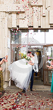 Guests Throwing Confetti Over Bride And Groom At Wedding Stock Photo