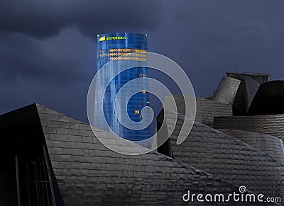 The Guggenheim Museum Bilbao with Iberdrola Tower in the background Editorial Stock Photo