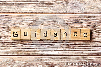 Guidance word written on wood block. Guidance text on table, concept Stock Photo