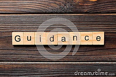 Guidance word written on wood block. Guidance text on table, concept Stock Photo