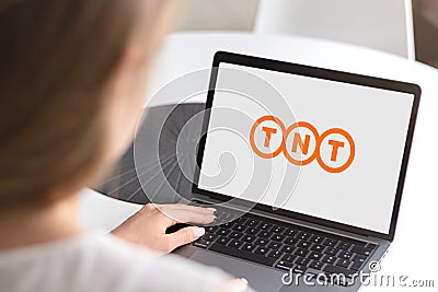 Woman with laptop - TNT logo Editorial Stock Photo