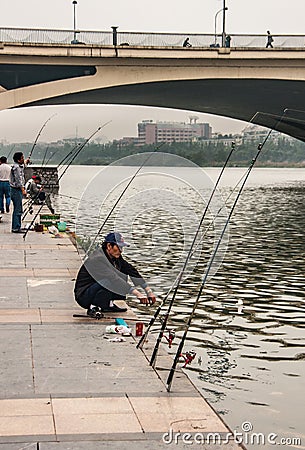 Several men fish from quay along Li River, Guilin, China Editorial Stock Photo