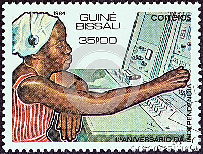 GUINEA-BISSAU - CIRCA 1984: A stamp printed in Guinea-Bissau shows telephonist and switchboard, circa 1984. Editorial Stock Photo