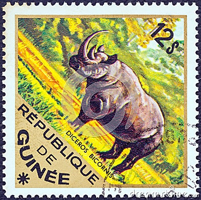 GUINEA - CIRCA 1975: A stamp printed in Guinea from the `Wild Animals` issue shows a Black Rhinoceros Diceros bicornis Editorial Stock Photo