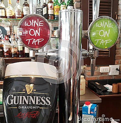 Guiness and wine beertaps Editorial Stock Photo