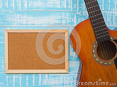 The guitar and board on blue wooden texture background. Music da Stock Photo