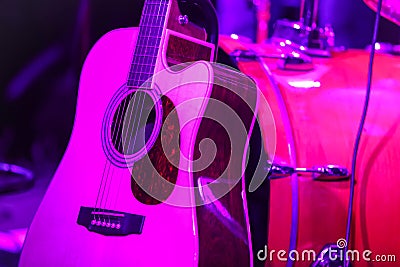 Guitar with drums under violet light Stock Photo