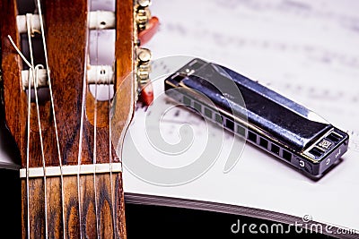 Guitar and harmonica with notes Stock Photo