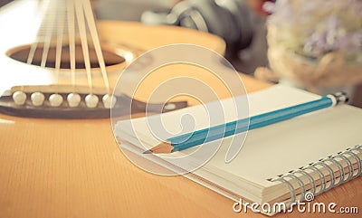 Guitar with notebook for music songwriting Stock Photo