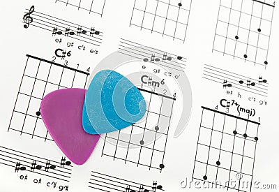 Guitar picks on a chords chart Stock Photo