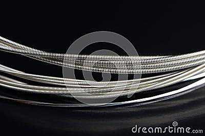 Guitar Strings Close-Up on Glossy Black Background Stock Photo