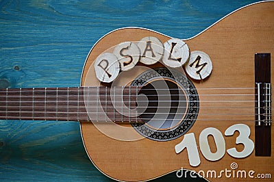 Guitar on teal wood with the word: PSALM 103 Stock Photo