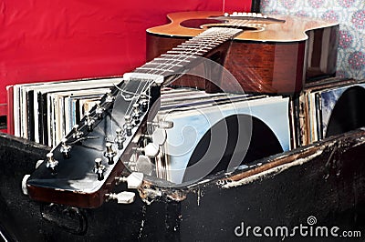 Guitar on a trunk full of old vinyl records Stock Photo