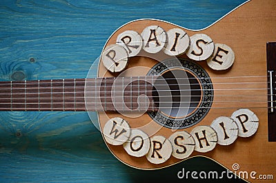 Guitar on wood with words: PRAISE and WORSHIP Stock Photo