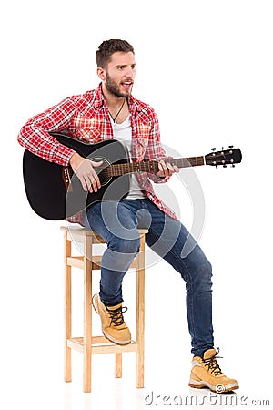 The guitarist on a chair Stock Photo