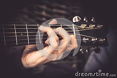 Guitarist Playing song on acoustic guitar fretboard chord vintage style Stock Photo