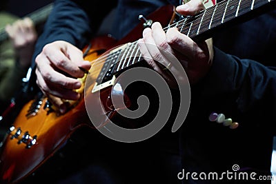 Guitarist hands plays guitar solo, close-up. A singer man playing guitar Stock Photo