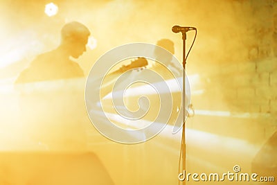 Guitarist silhouette perform on a concert stage. Abstract musical background. Music band with guitar player. Playing Stock Photo
