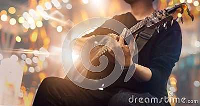 Guitarist on stage and sings at a concert for background, Stock Photo