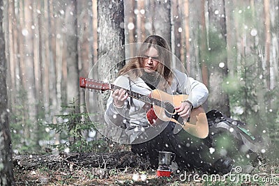 Guitarist in the woods at a picnic. A musician with an acoustic Stock Photo