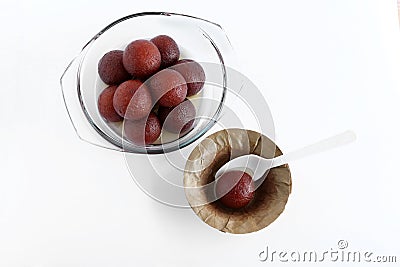 Gulab Jamun Traditional and Popular Indian Sweet Dish in a Glass and Leaf Bowl Stock Photo