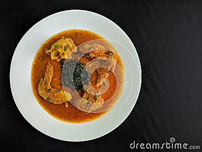 Gulai Ayam is traditional Indonesian dish of chicken cooked in a spicy, rich, yellowish, curry-like sauce called gulai Stock Photo