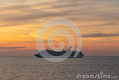 Gulf of Mexico - April 5, 2020: Shot of Carnival Valor anchored at sea. Beautiful sunset orange sky in the background and calm Editorial Stock Photo