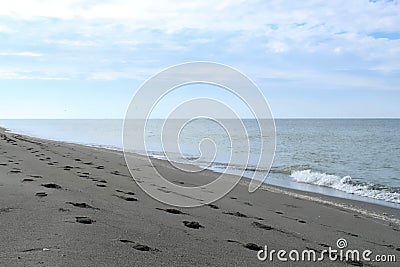Footprings on a Gulf of Mexico white-sand beach after sunrise Stock Photo