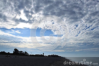 Cirrocumulus clouds being to part after sunrise on the Gulf of Mexico Stock Photo