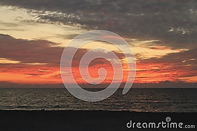 Gulf of Mexico sunset burns the sky with its brilliant colors Stock Photo