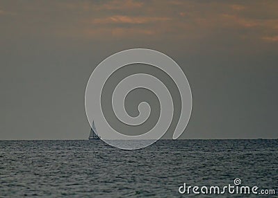 Sailboat againt the horizon during the end of a Gulf of Mexico sunset Stock Photo