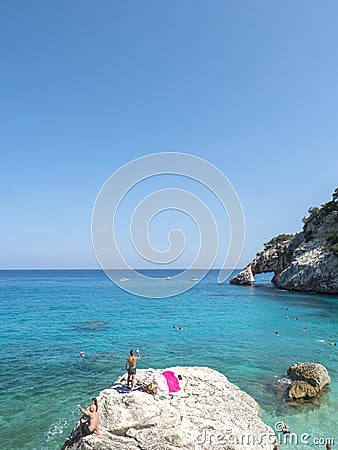 Gulf of Orosei, Sardinia, Italy, September 8, 2020: A view of yopung woman sunbathing at Cala Goloritze beach with Editorial Stock Photo