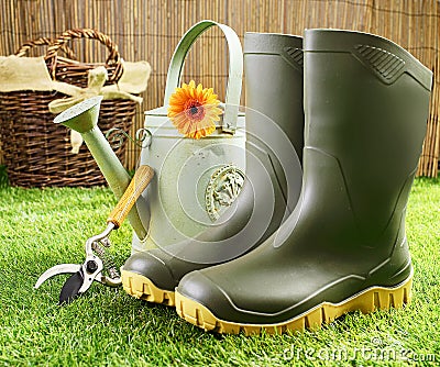 Gumboots and gardening tools Stock Photo