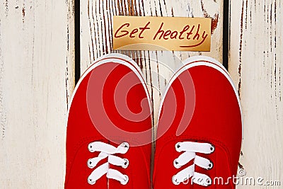 Gumshoes and motivation card. Stock Photo