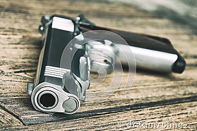 Gun Barrel, 1911 Model, Semi-automatic handgun on wooden background. Stock Photo