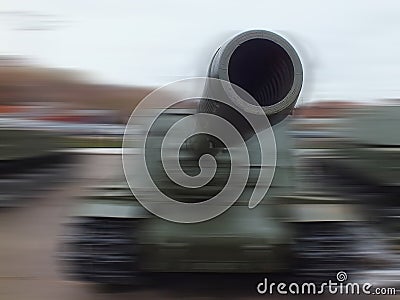 Tank gun close up on blurred background. The concept of aggression Stock Photo