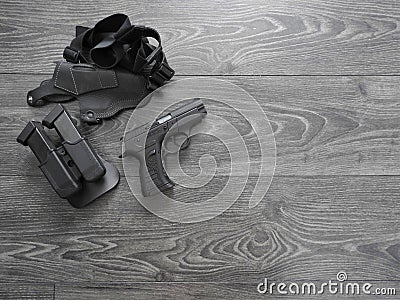 Gun black, spare magazines and leather holster on grey background Stock Photo