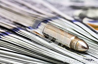 Gun bullet laying on american dollars background Stock Photo