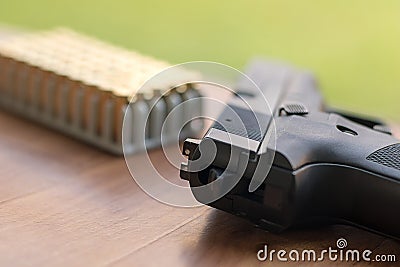 Gun with bullets. Handgun box with new ammunition. Stock Photo