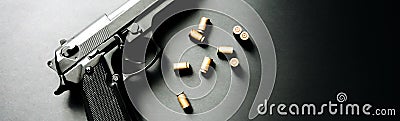 Gun with bullets lying on the table. Legalising of weapons. Criminal problems Stock Photo
