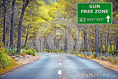GUN FREE ZONE road sign against clear blue sky Stock Photo