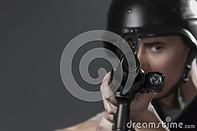 Gunfire, paintball sport player wearing protective helmet aiming Stock Photo
