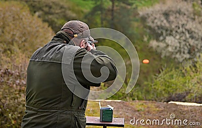 Gunman shooting the asphalt pigeon Stock Photo