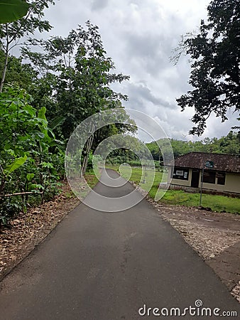 POV in over head shot from a motorbike driving on a village road. Editorial Stock Photo