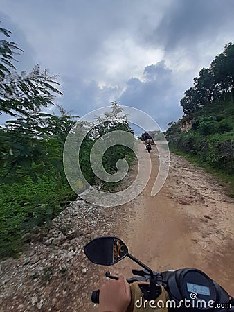 POV in over head shot from a motorbike driving on a country path. Editorial Stock Photo